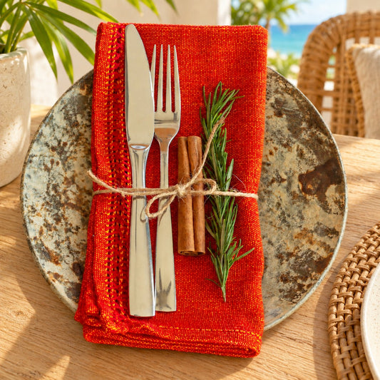 Napkins — Festival Red with ceramic plate in a tropical coastal setting